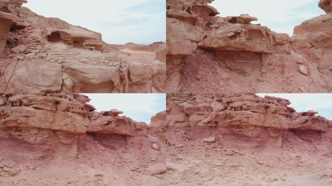 带有红色岩石地层的沙漠上的滑动无人机视图
