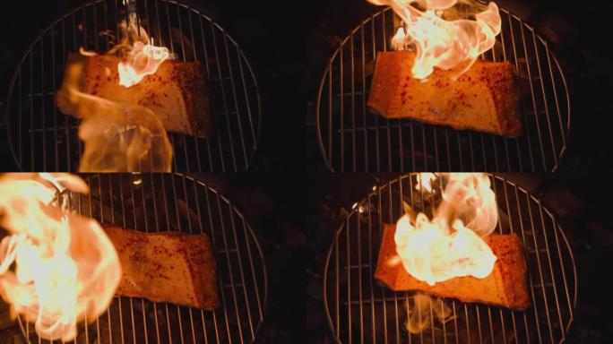 在火盆上燃烧着明亮的火烧着鳟鱼的红鱼