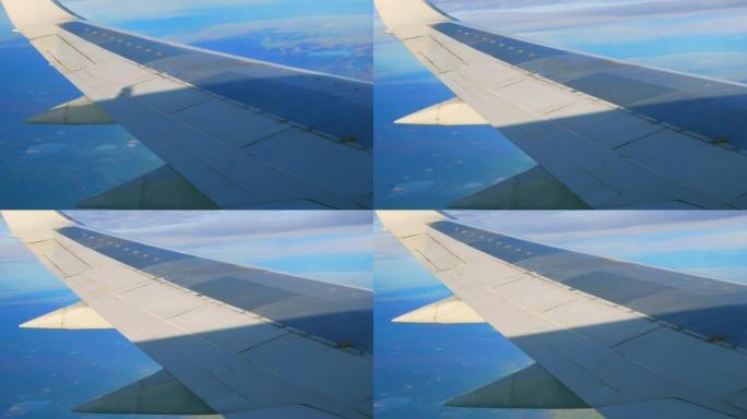 一架掉头的客机机翼的特写镜头。从乘客座椅上的eluminator看到衬板翼。通过乘客的眼睛在飞机上飞
