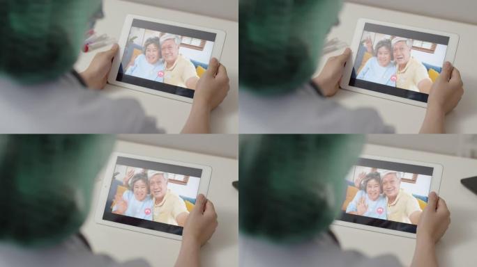 女医生在新型冠状病毒肺炎大流行期间在医院工作时使用平板电脑视频通话给父亲和母亲。