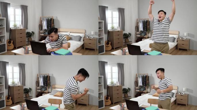 快乐的亚洲男性收到成功的在线新闻正站在椅子上，兴奋地尖叫着，握紧拳头在家里的卧室里。