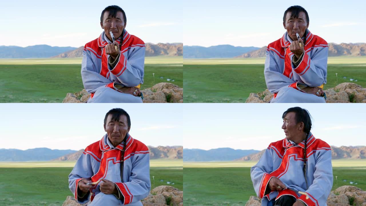 身着传统服饰的蒙古族牧民在西部阿尔泰山附近抽烟。