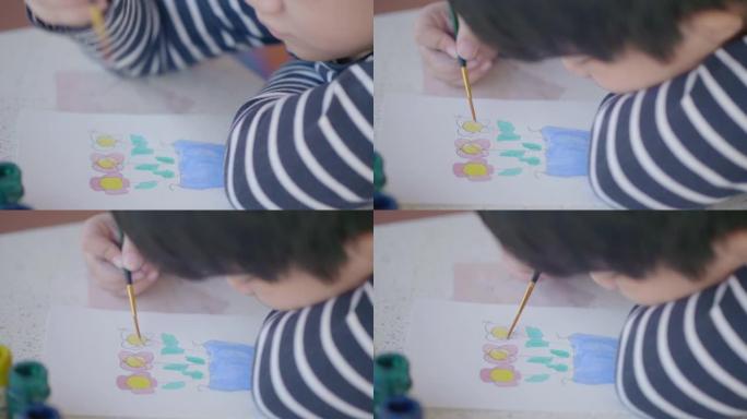 亚洲男孩在家画水彩花