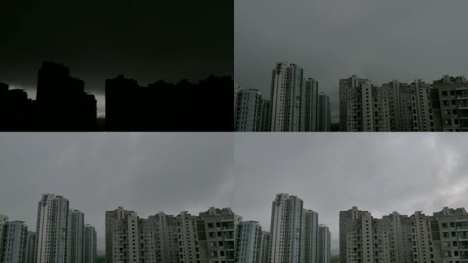 时光倒流。乌云穿过公寓楼的顶部。雨开始了，天空变黑了，云很快就过去了。