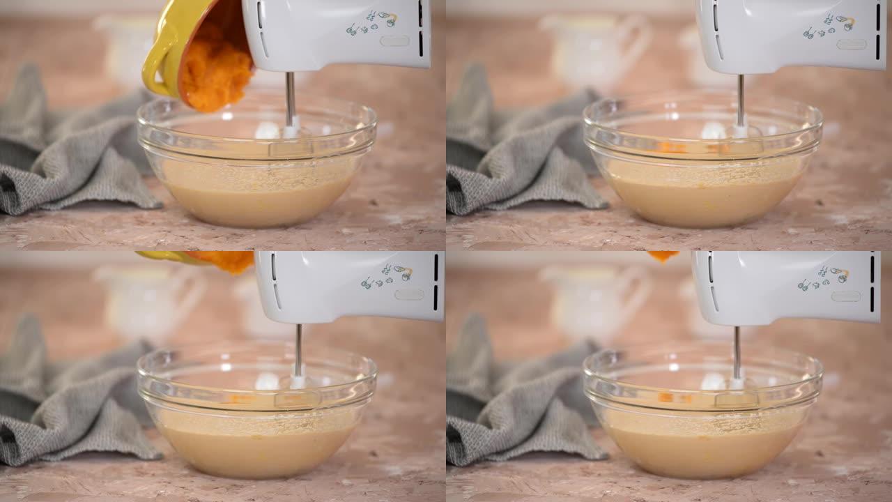 纸杯蛋糕的制备过程。在面团中加入南瓜。