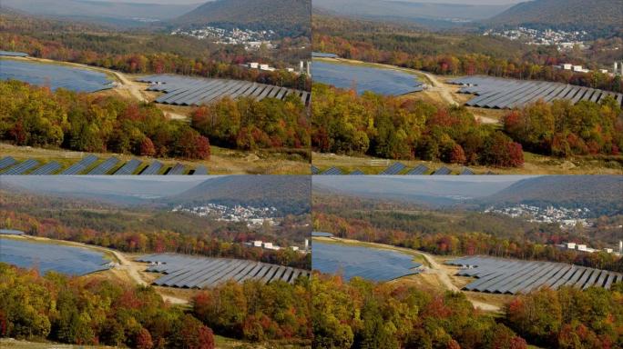宾夕法尼亚州阿巴拉契亚山脉的大型太阳能农场，在一个五颜六色的秋天。带有转发摄像机运动的航空视频。