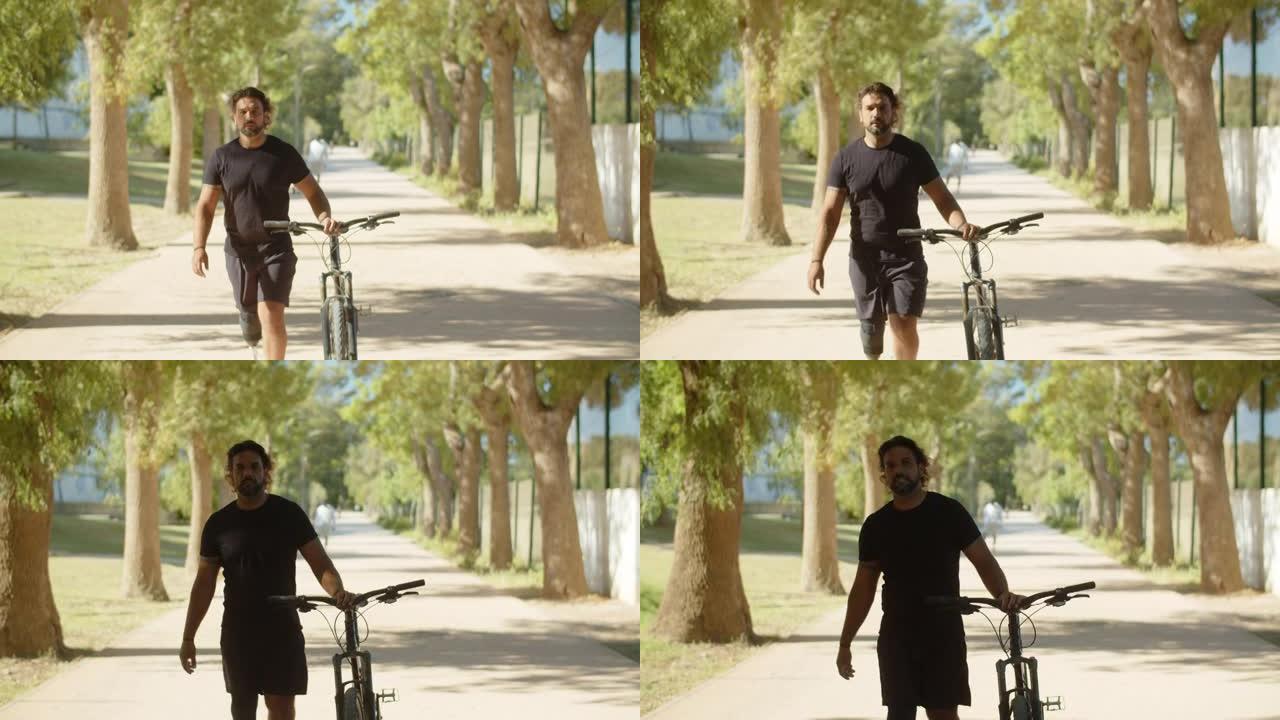 公园里用自行车走路的仿生腿男子的前视图