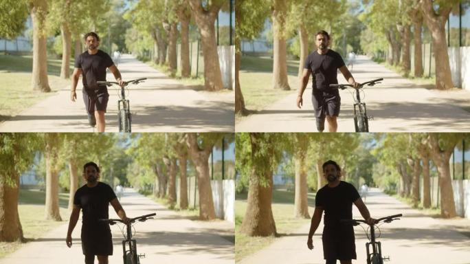 公园里用自行车走路的仿生腿男子的前视图