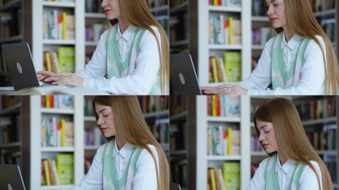 在图书馆使用笔记本电脑的学生
