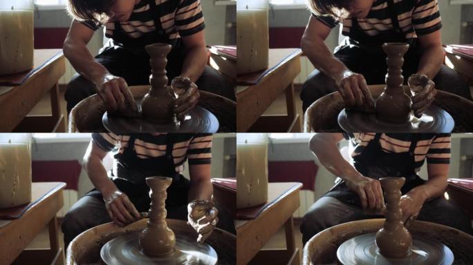 一个男陶工在陶工的轮子上创造了一个漂亮的浮雕花瓶。
