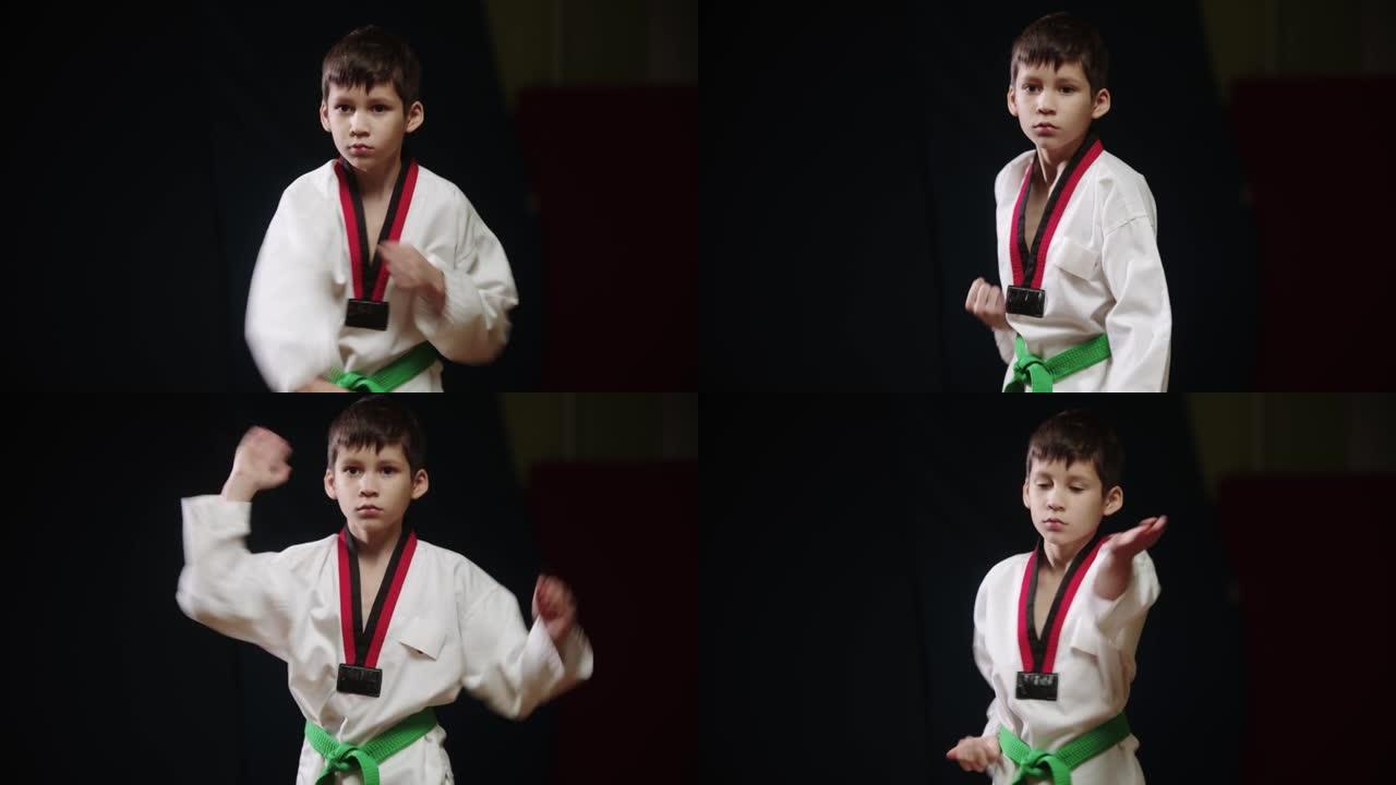 一个穿着白色制服的小男孩做跆拳道-站立并展示动作