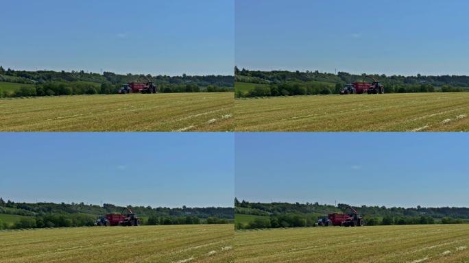 捷克共和国Skutec，2021年6月2日: 饲草拖拉机清除田地上的割草，将青贮饲料装载到拖拉机拖车