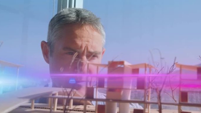 男性建筑师看着建筑模型的粉红色光束和镜头耀斑的动画