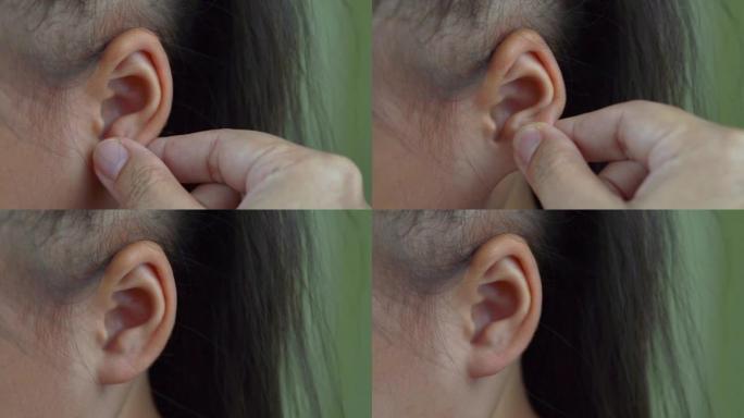 亚洲母子女孩玩捏耳朵，摸鼻子滑稽的脸。