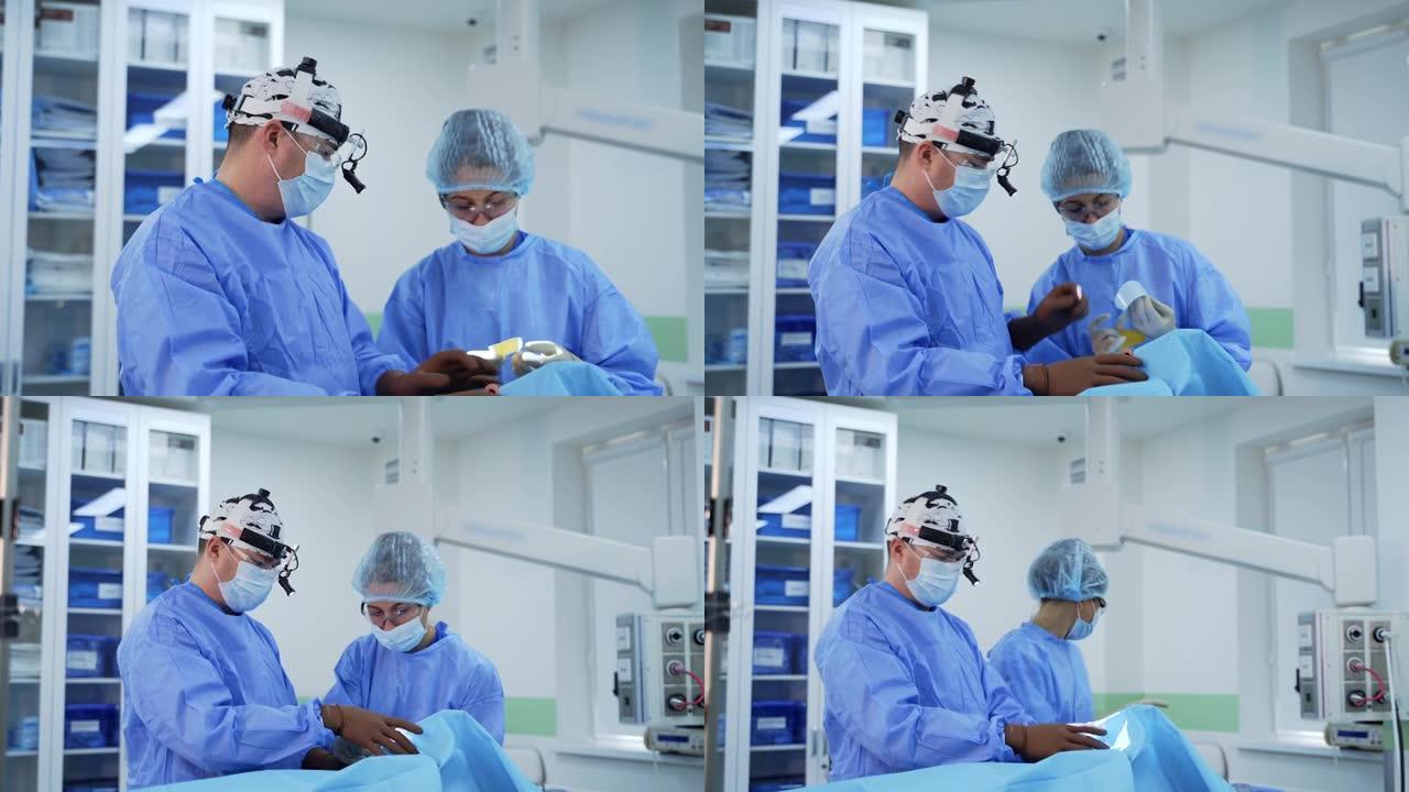 手术室的手术。医生和一名穿着蓝色医疗制服的护士在现代诊所对患者进行手术。