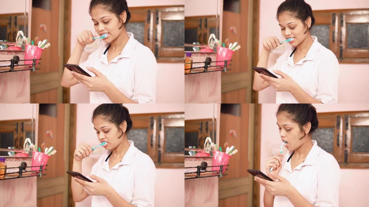 印度年轻女子一边刷牙一边看智能手机。