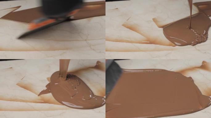 用刷子将融化的巧克力或巧克力奶油铺在白色大理石表面上