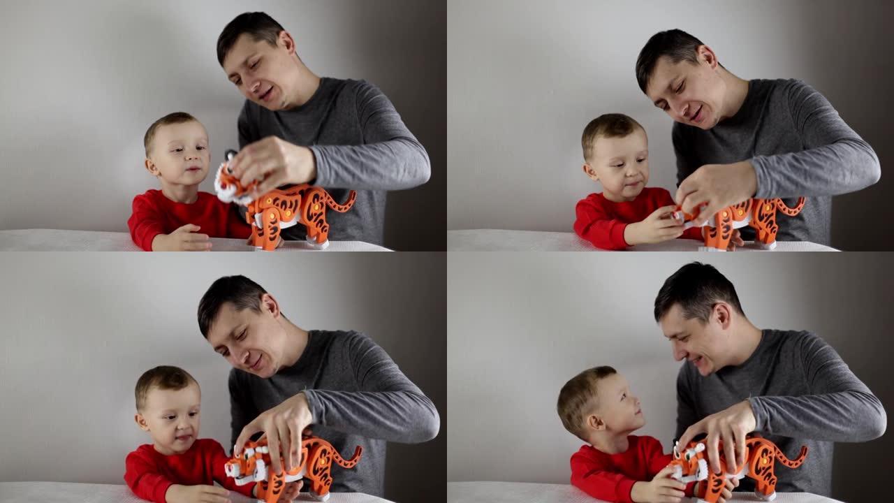 快乐爸爸帮助可爱的学龄前儿童儿子组装3D老虎拼图。根据中国的日历，老虎是2022年的象征。一个有爱心