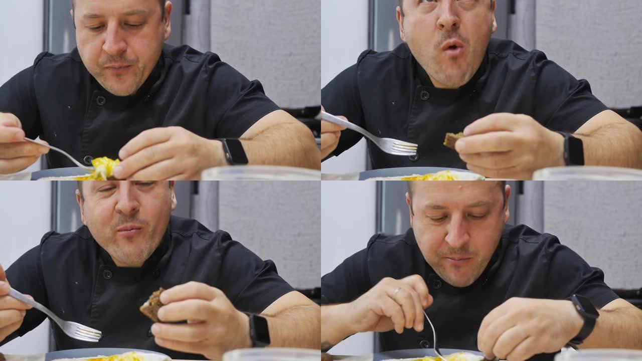 肖像。那个人在吃饭。用叉子吃煎蛋和黑面包。