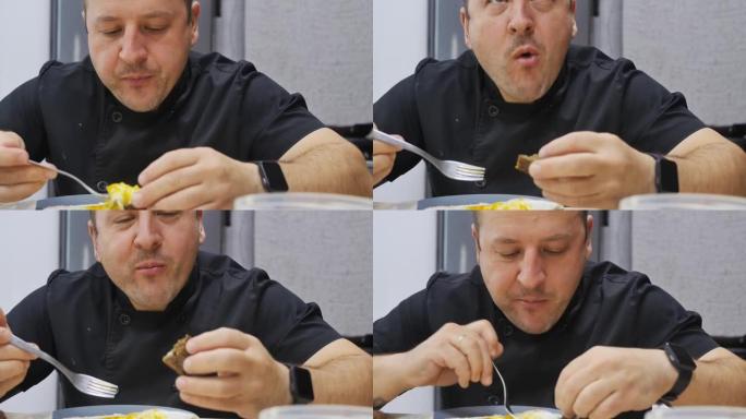 肖像。那个人在吃饭。用叉子吃煎蛋和黑面包。