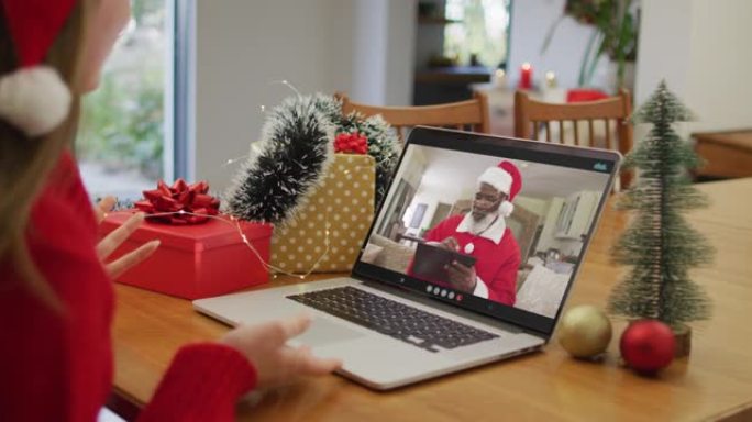 快乐的白人妇女在圣诞节与圣诞老人进行视频通话
