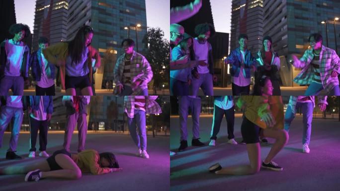 年轻的亚洲中国女孩晚上在城市的音乐街派对上与Z世代的朋友一起跳舞