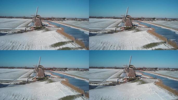 在厚厚的积雪下，海牙附近的Molendriegang Drie Molens的航拍镜头