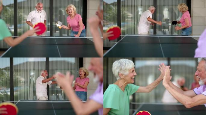 顽皮的老年人在打乒乓球时玩得很开心。