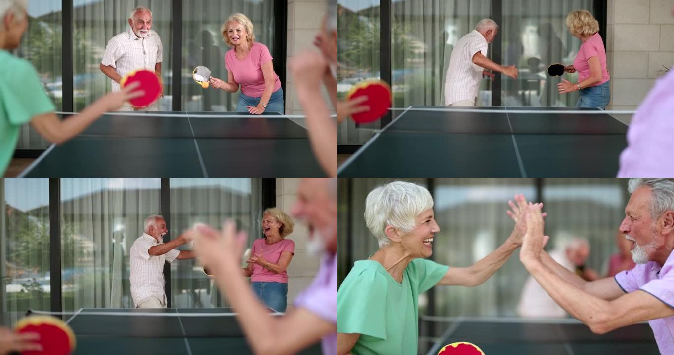 顽皮的老年人在打乒乓球时玩得很开心。