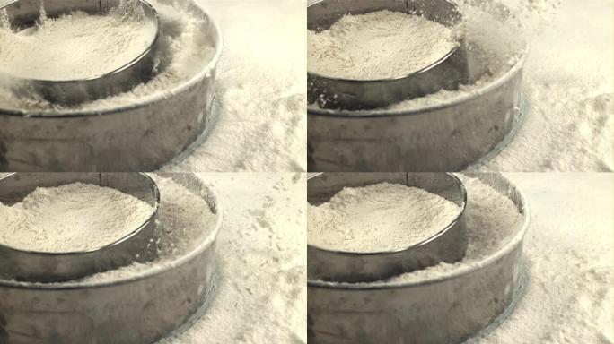 用面粉的筛子的超慢动作落在桌子上。以1000 fps的高速相机拍摄。