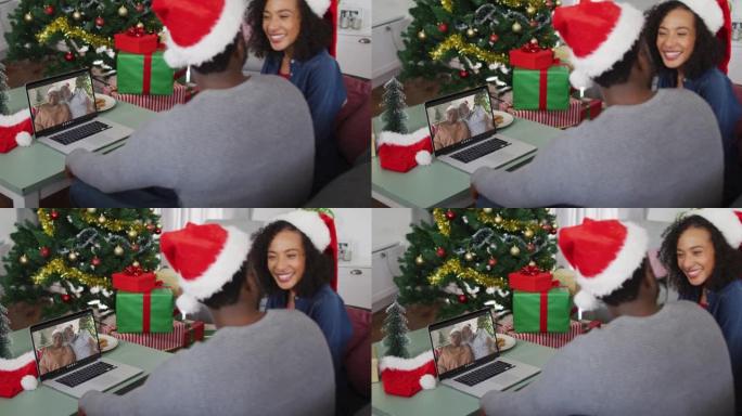 快乐的非洲裔美国夫妇在圣诞节期间与资深父母在笔记本电脑上进行视频通话