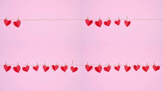 情人节停止了挂在粉红色主题绳子上的心的运动