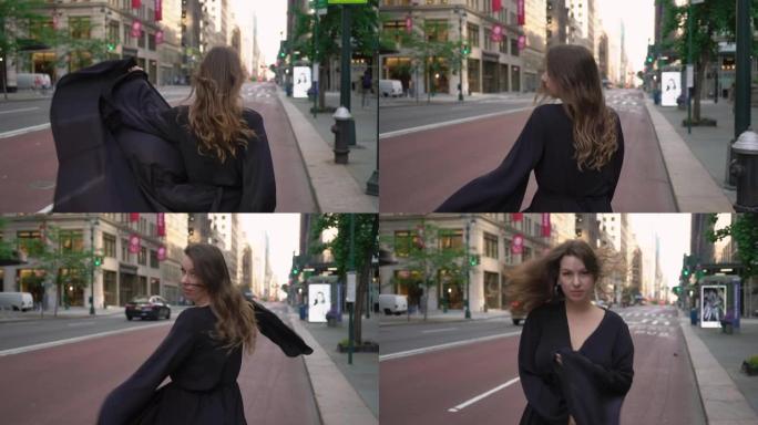 穿着黑色长裙的女孩穿过纽约曼哈顿的街道