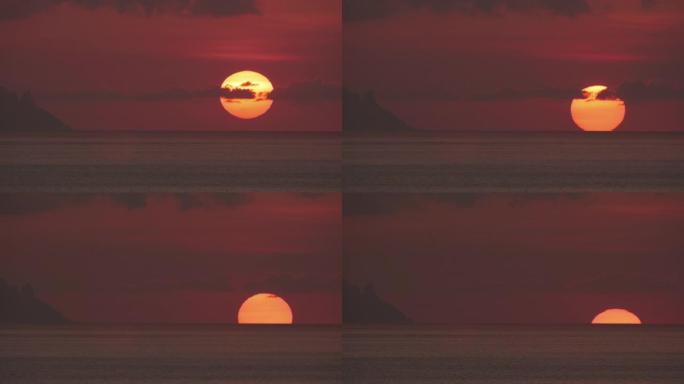 壮丽的神秘血红色的海洋日落。巨大的南方太阳坐在海洋地平线后面