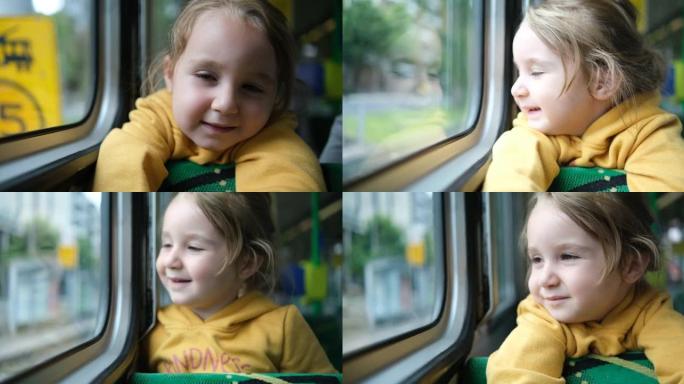 可爱的小女孩在电车上看着窗外的肖像
