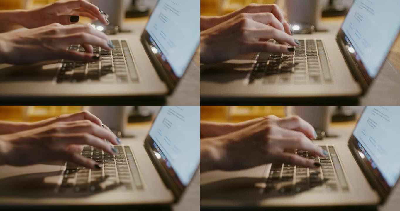在笔记本电脑上打字整齐的女性双手特写