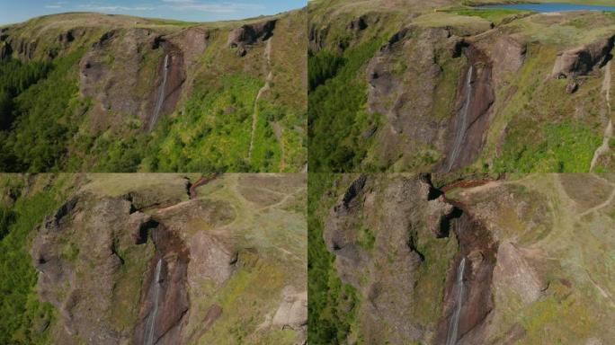 鸟瞰清新的绿色场景冰岛草地和瀑布。无人驾驶飞机的风景，冰岛有绿草如茵的高地。风景如画的乡村景观