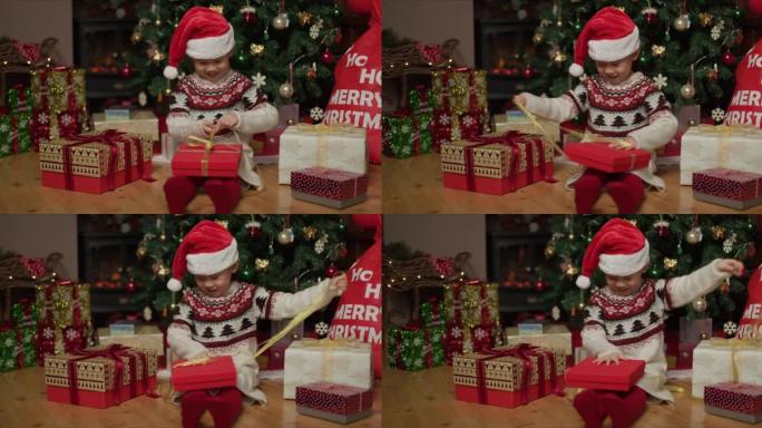 年轻女孩在家里的圣诞树旁边打开圣诞礼品盒