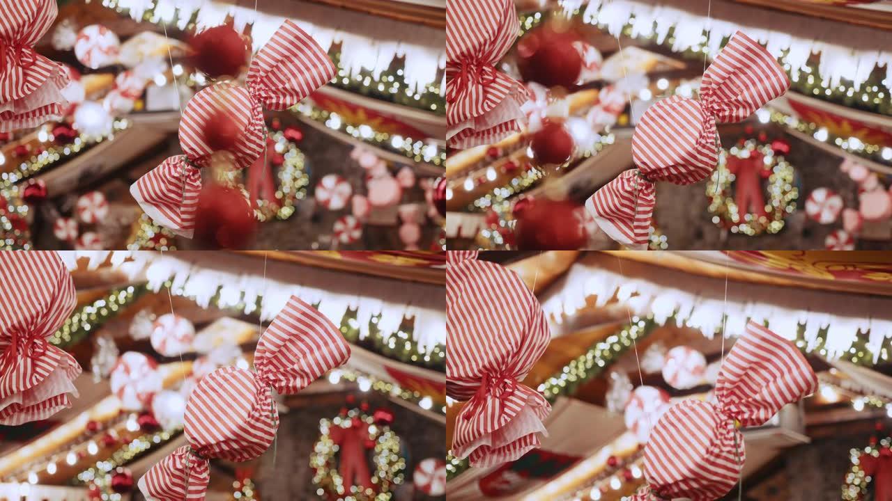 糖果形式的大型圣诞节装饰挂在漂亮的房子或商店里。新年树上的圣诞舞会和装饰糖果，圣诞气氛，圣诞快乐和新