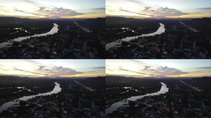 黄昏时乡村小镇河流的空中场景