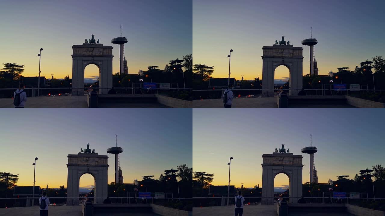 西班牙马德里蒙克洛亚区的Arco de la Victoria，日落时灯塔