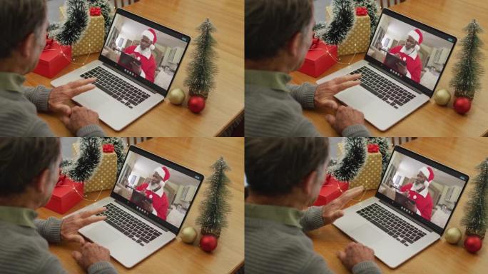 圣诞节时与圣诞老人进行视频通话的白人高级男子