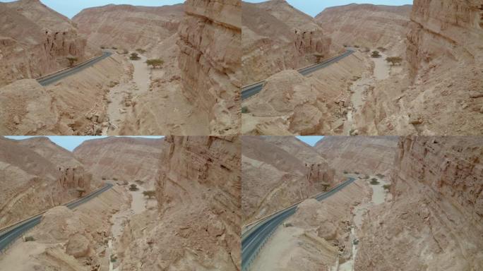 沙漠山脉岩石悬崖构造之间的道路高视图