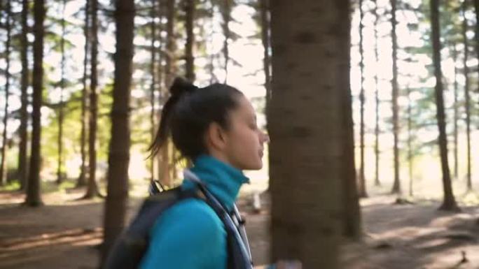 穿着运动服的女越野跑者，穿越森林