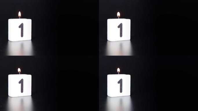 一根方形蜡烛，上面写着数字1被点燃并吹出，庆祝生日或周年纪念日。
