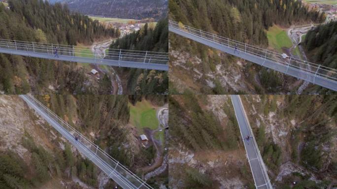 女孩在瑞士穿越一条山沟的人行天桥