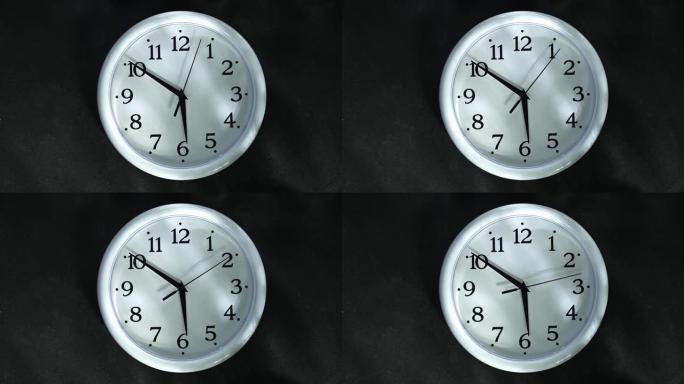 黑色背景上的白色时钟。秒手去6点。晚上或早上。