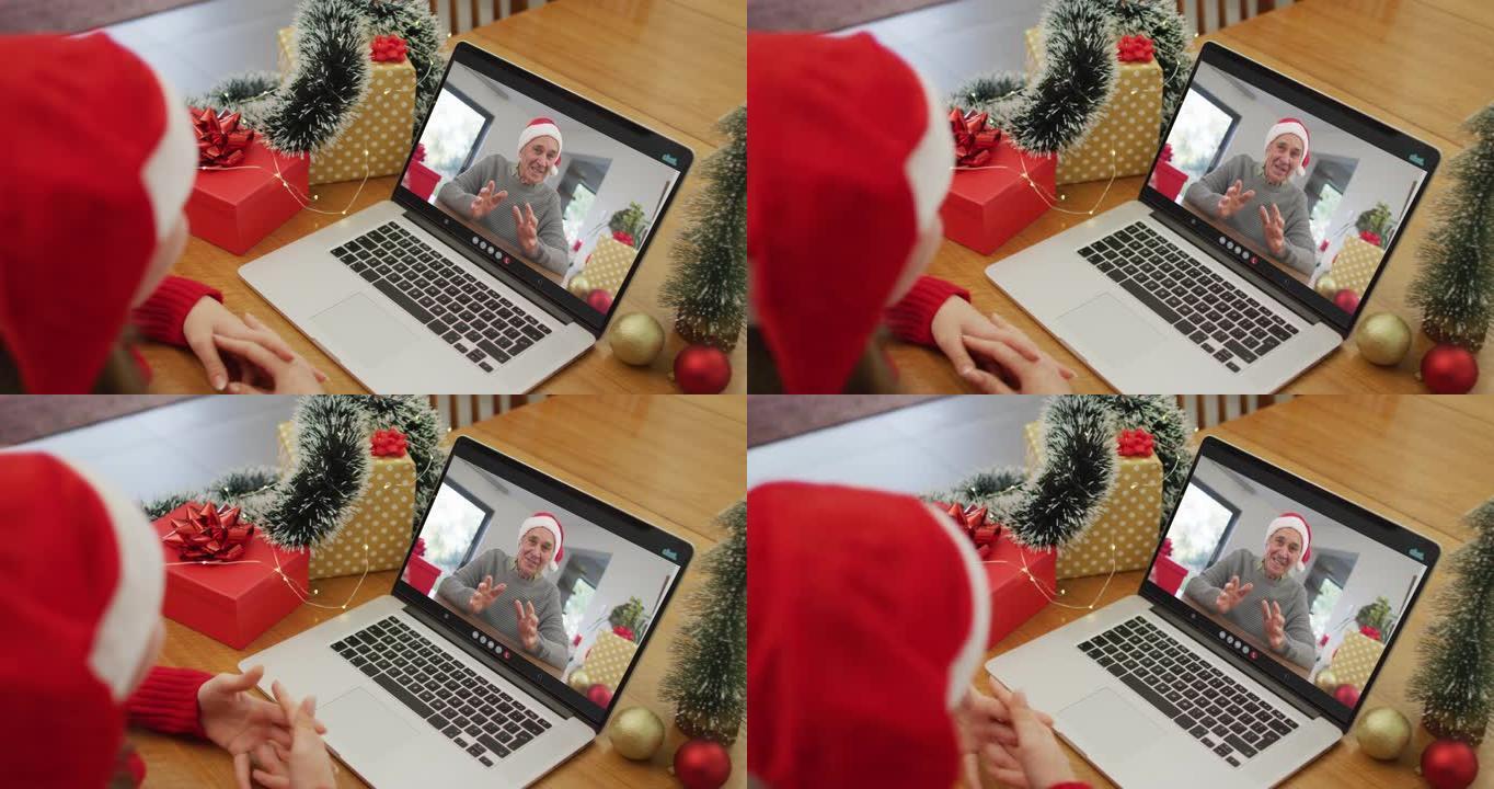 快乐的白人妇女在圣诞节与祖父进行视频通话