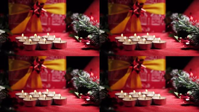 圣诞蜡烛和礼物装饰。红色背景上的蜡烛灯。寒假庆典