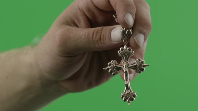 一个男人的手握着一个宗教十字架